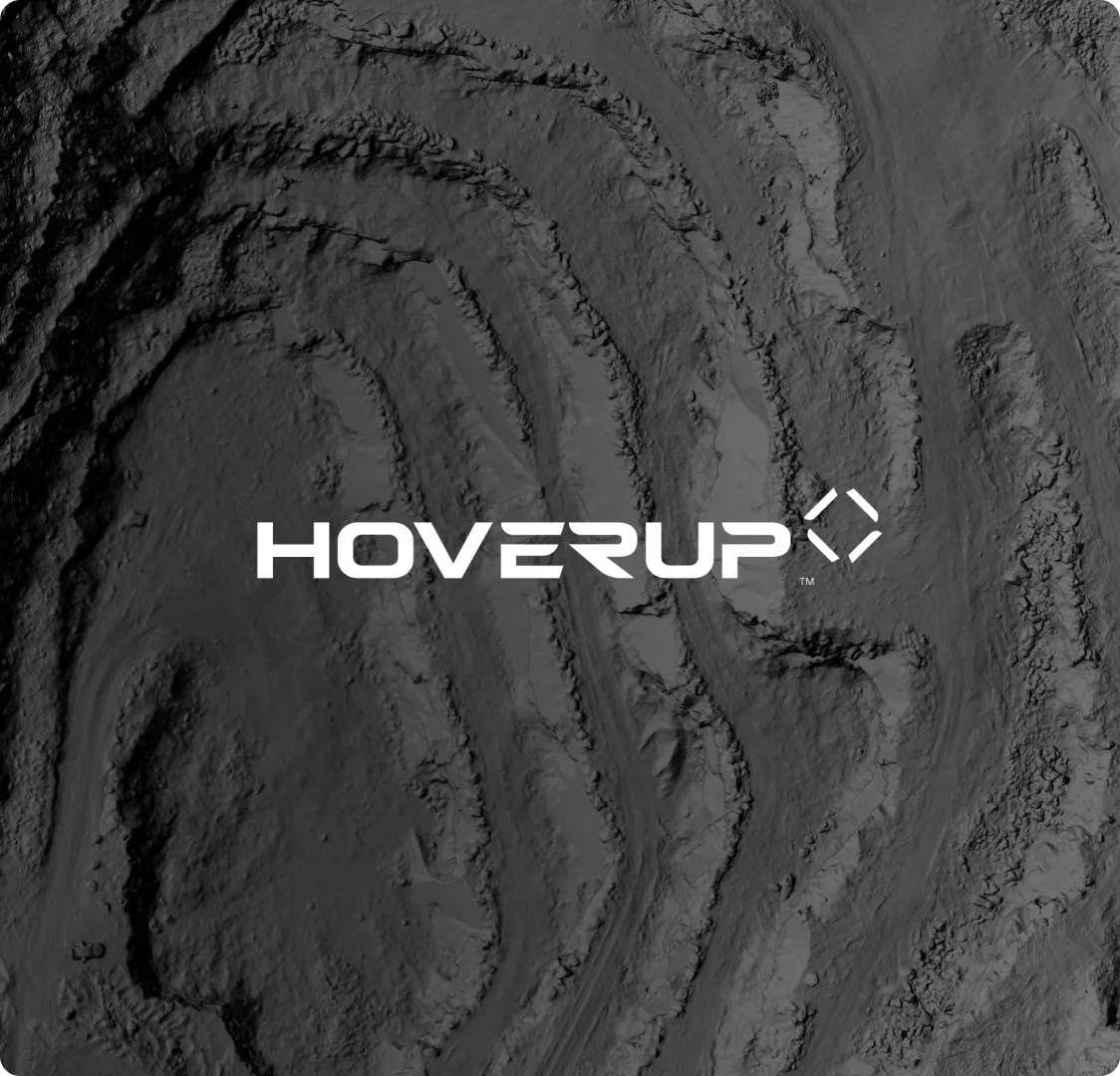 The company wordmark in white over a greyscale aerial survey image of terraced ground.