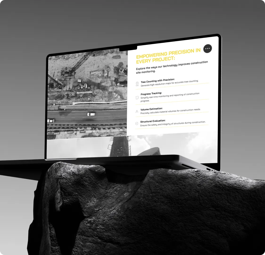 A laptop showing the Hover Up construction site monitoring page, with a list of what the flights measure beside an aerial photograph of a site.