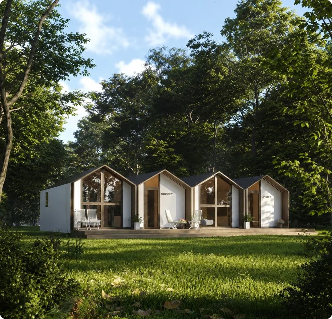 A row of gable-roofed Odyssey cabins on a shared timber deck in a clearing, with chairs out the front.