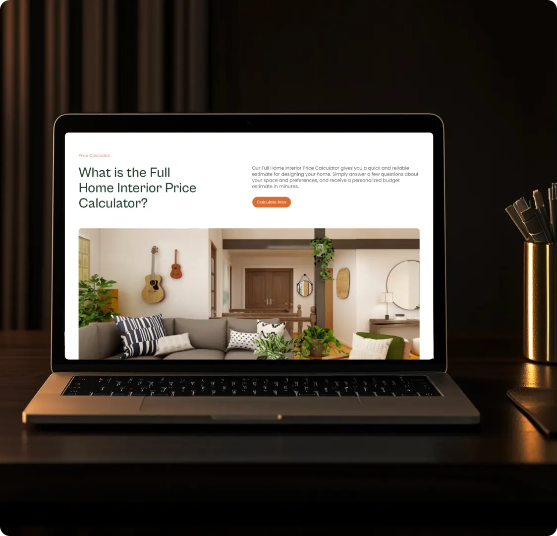 A laptop on a dark desk showing the Tranquil Decor price calculator page, with a Calculate Now button and a photo of a living room underneath.