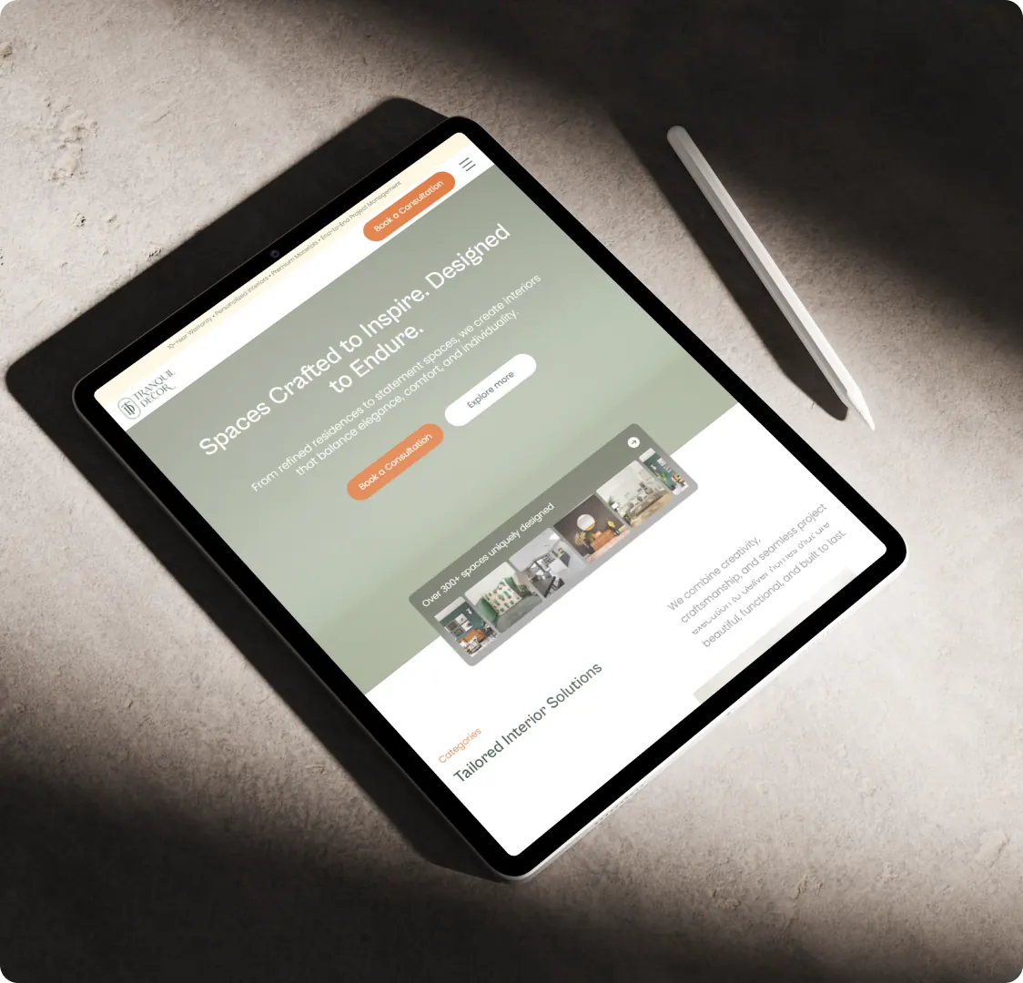 A tablet lying flat on a stone surface, showing the homepage hero and the start of the categories section.