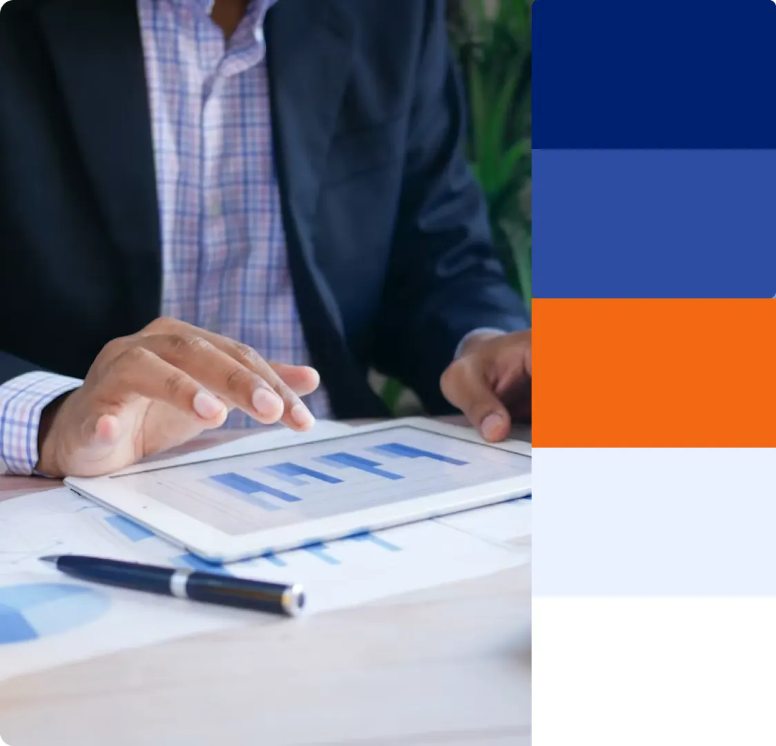A photograph of someone using a tablet with charts on the screen, beside the unbordered colour swatches in navy, blue, orange, pale blue and white.